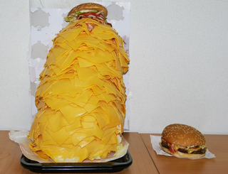 Illustration for article titled A Whopper with 1,000 Slices of Cheese Will Horrify and Disgust You
